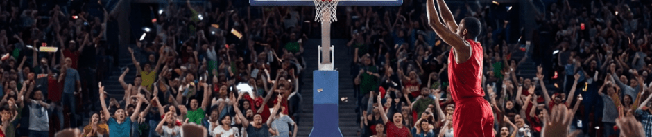 Basketball player in red shooting a final shot in a crowded stadium at the buzzer.